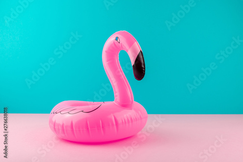 Photography Inflatable pink flamingo on pastel blue and pink background