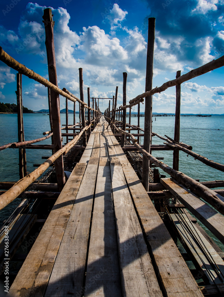 A wooden bridge with a path to the sea. A wooden bridge with a path to the sea.