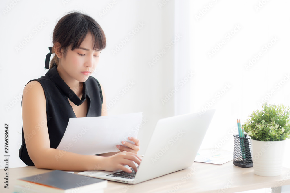 Beautiful asian woman working and typing with laptop computer at office, businesswoman looking graph diagram analysis statistic data of finance, girl using notebook, profit growth, business concept. Beautiful asian woman working and typing with laptop computer at office, businesswoman looking graph diagram analysis statistic data of finance, girl using notebook, profit growth, business concept.