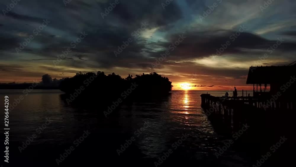 Sunrise Drone shot Raja Ampat aerial bird eye view of islands stilted houses over water Sunrise Drone shot Raja Ampat aerial bird eye view of islands stilted houses over water