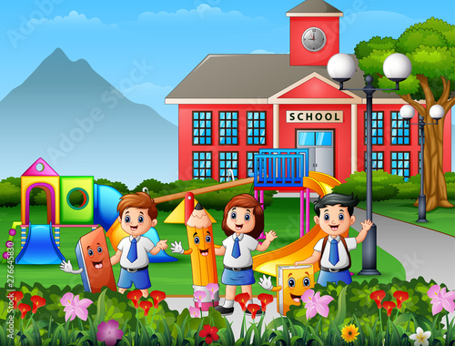 Happy school children holding stationery in the school yard