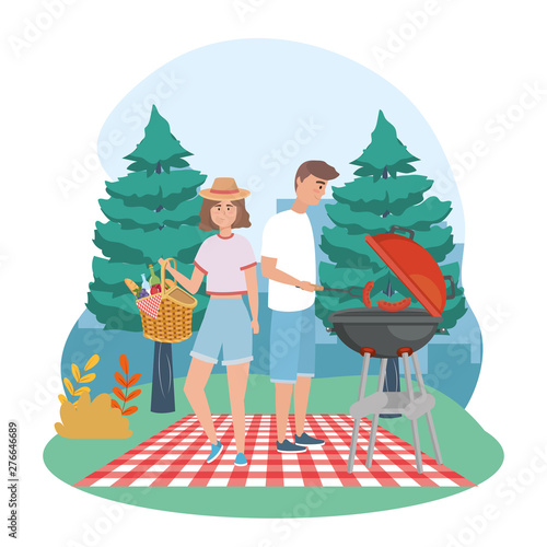 man and woman with grilled sausages and hamper with food