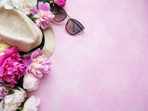 Fototapeta Naklejka Na Ścianę i Meble -  Pink peonies and hat on a pink concrete background