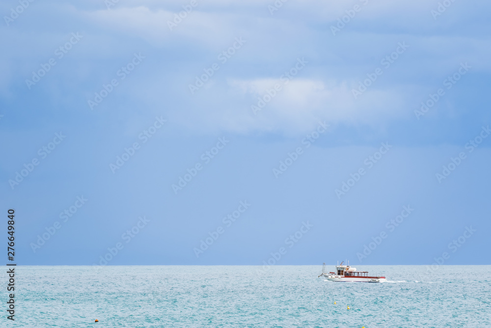 Boat on the Tyrrhenian Sea seen from the Minori and Maiori Beach, Amalfi Coast, Campania, Italy