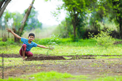 kid planting tree and showing empty board