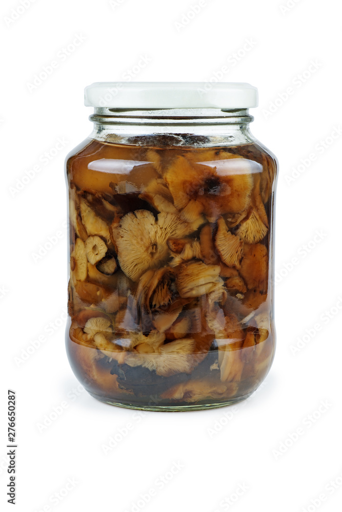 Glass jar with pickled (marinated) honey fungus (mushrooms) isolated on white background Glass jar with pickled (marinated) honey fungus (mushrooms) isolated on white background