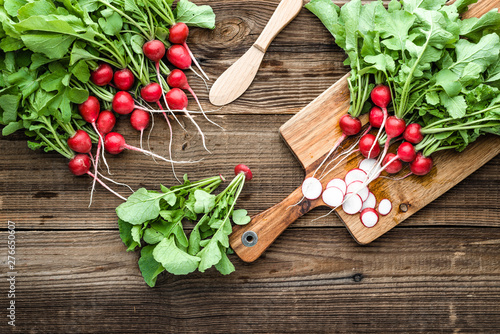 Bio organic vegetables. Fresh red radish on cutting board. Clean vegetables, harvested freshly garden radishes on wood.