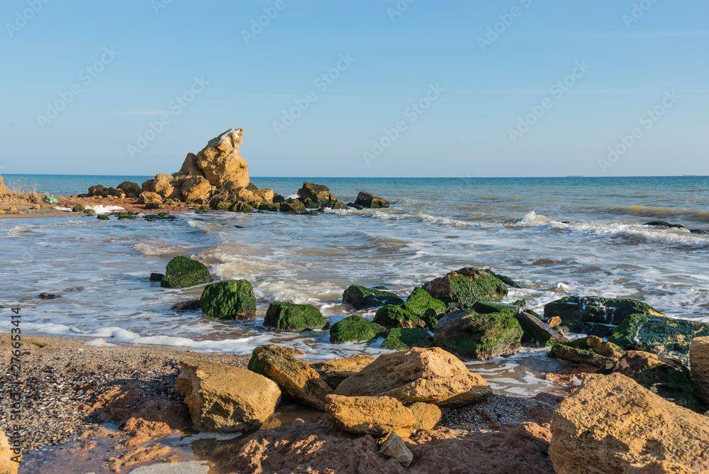 A scattering of large stones by the sea