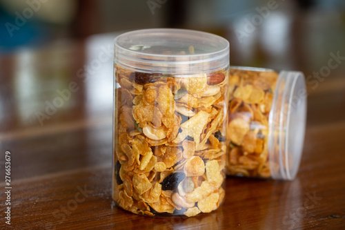 Homemade organic healthy granola with dried fruits in bottles