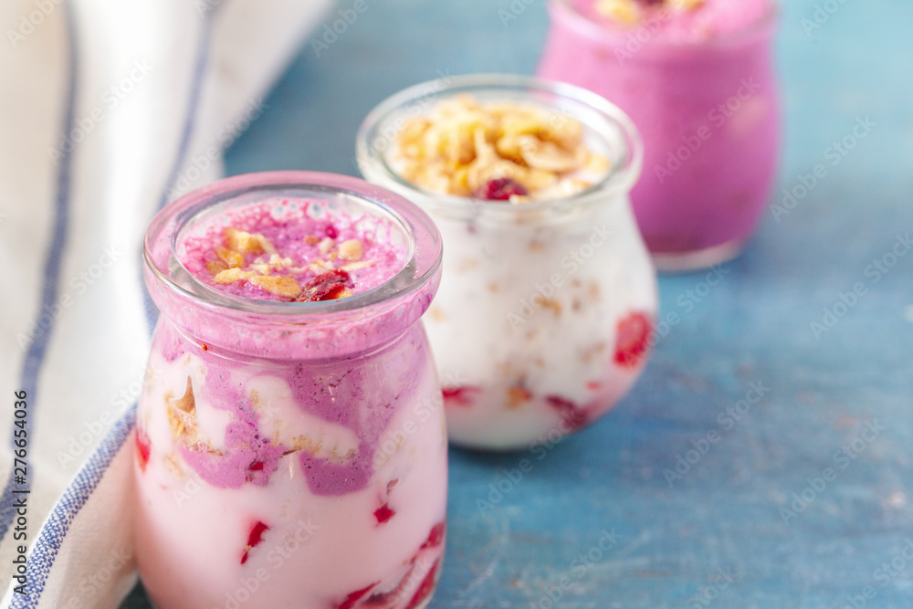 healthy products for breakfast, granola and fresh berries on white table
