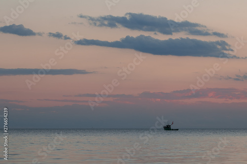 loneley fisherman boat at the sea