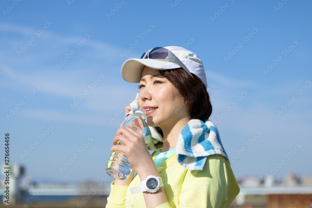 運動中に水分補給する女性