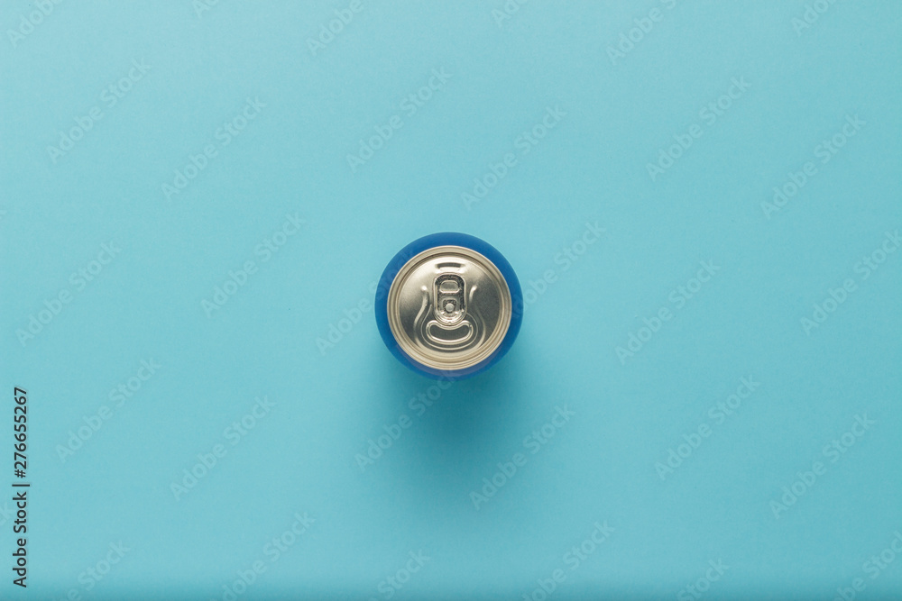 Tin can with a drink on a blue background. minimalism. Flat lay, top view Tin can with a drink on a blue background. minimalism. Flat lay, top view