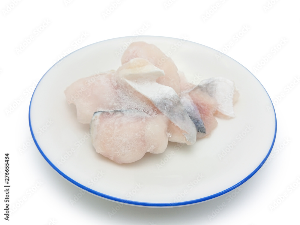 Slice frozen fish on the round plate isolated on white background