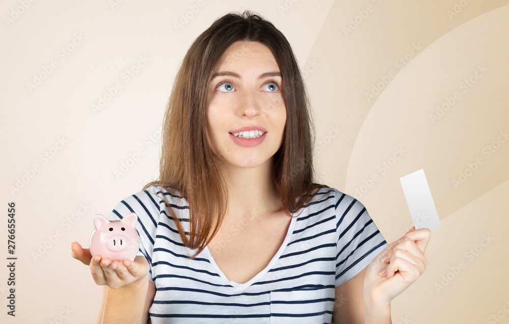 young woman 20s in casual clothing holding piggybank with lots of money isolated young woman 20s in casual clothing holding piggybank with lots of money isolated