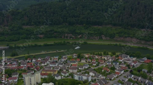 Aerial of the town Ersheim close to the castle Hirschhorn at the river Neckar on sunny day in spring. Pan to the right across the town with the river in the back photo