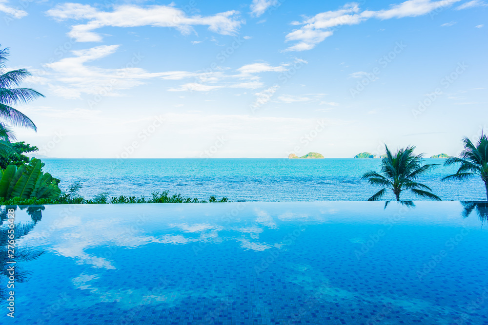 Fototapeta premium Umbrella and chair around beautiful luxury outdoor swimming pool with sea ocean view in hotel resort for holiday vacation travel