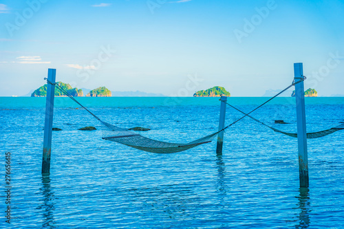 Empty hammock around beautiful beach sea ocean for relax in holiday vacation