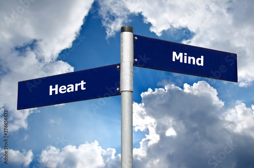 фотографія Street sign in front of cloudy sky representing choice between listening to the