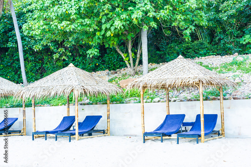 Umbrella and chair on the tropical beach sea and ocean