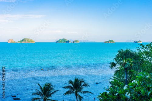 Beautiful outdoor beach sea ocean with coconut palm and other tree around island for travel in holiday vacation