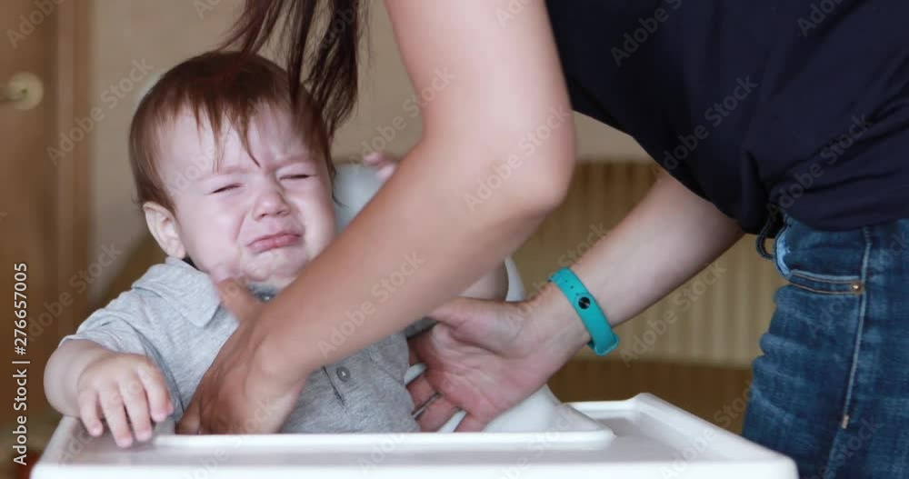 The baby is crying and mom comforts The baby is crying and mom comforts