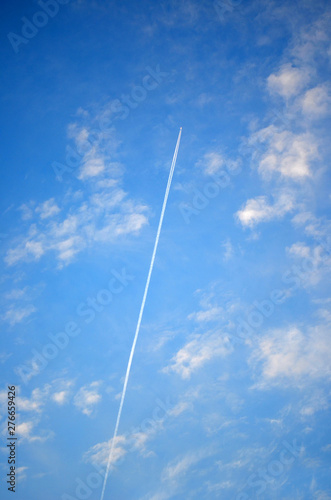 Airplane crossing blue sky leaving trail (Dubrovnik, Croatia)