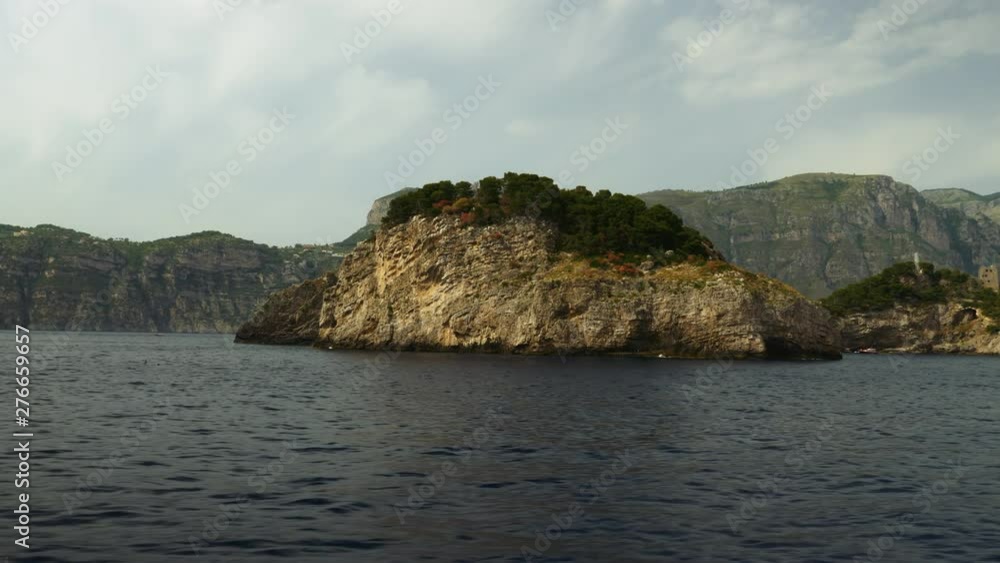 Floating by a beautiful rocky island in the Mediterranean ocean. Floating by a beautiful rocky island in the Mediterranean ocean.