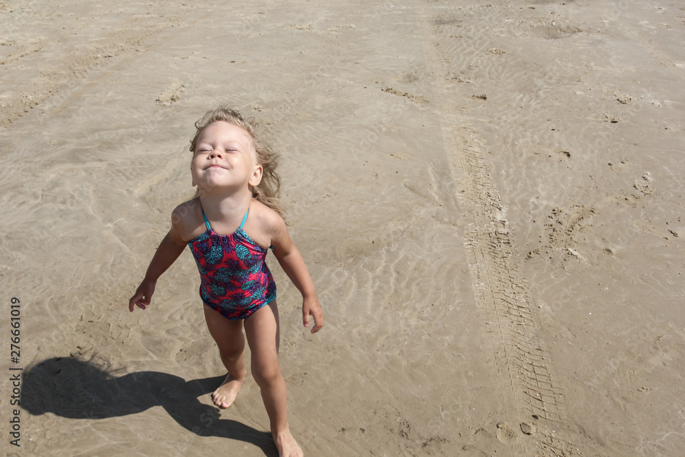 Happy little girl holding her face up to sun and sky Happy little girl holding her face up to sun and sky