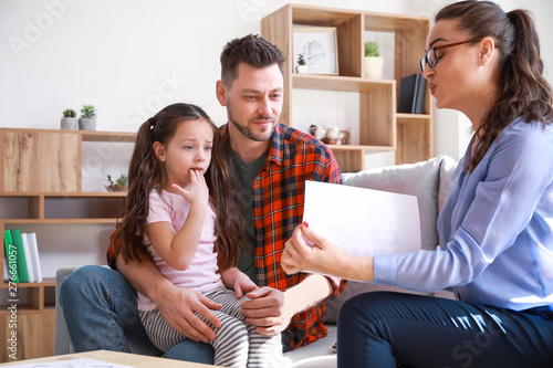 Female psychologist working with family in office