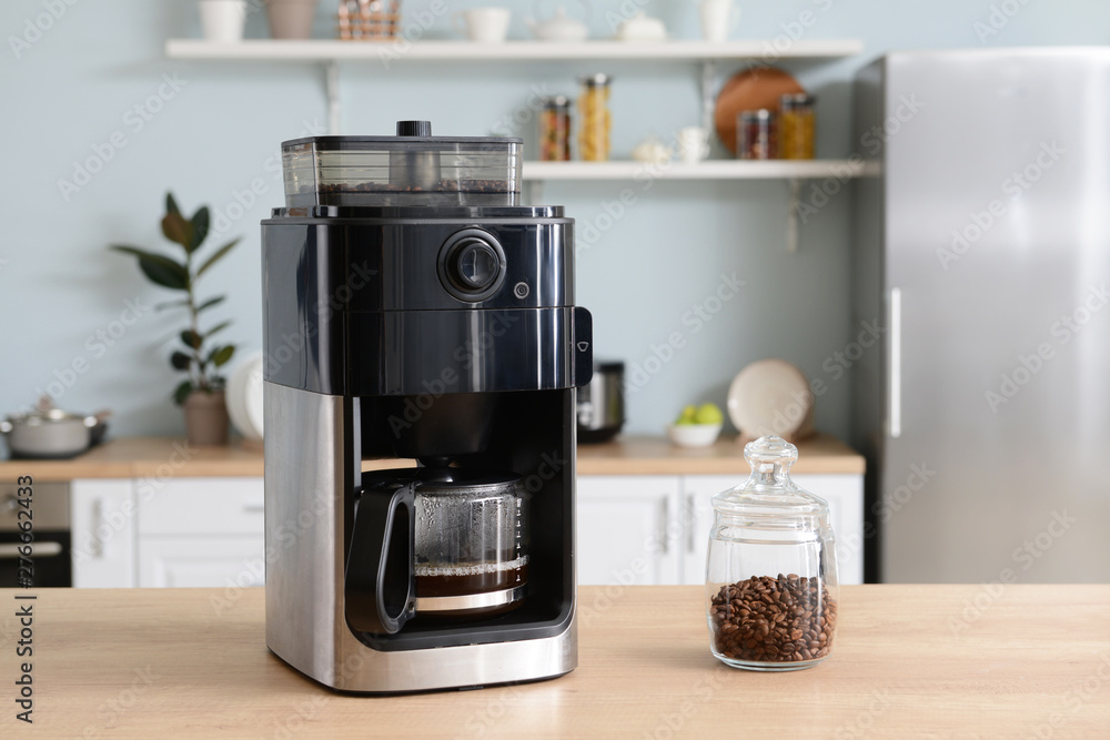 Modern coffee machine on table in kitchen Modern coffee machine on table in kitchen