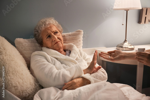 Senior woman refusing to ta...