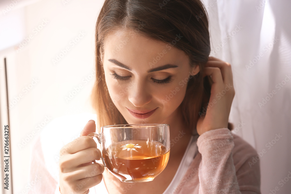 Beautiful young woman drinking tea at home Beautiful young woman drinking tea at home