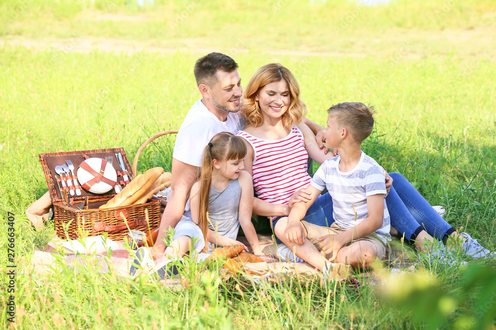 Happy family on summer picnic in park Happy family on summer picnic in park