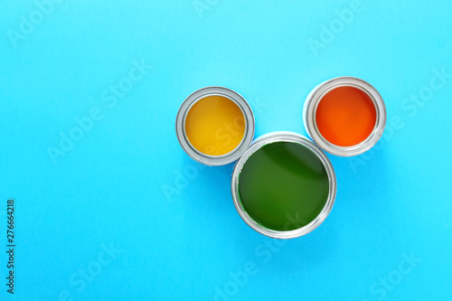 Three open paint cans with ...