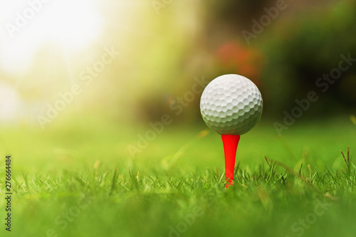 golf ball on green grass with sunrise