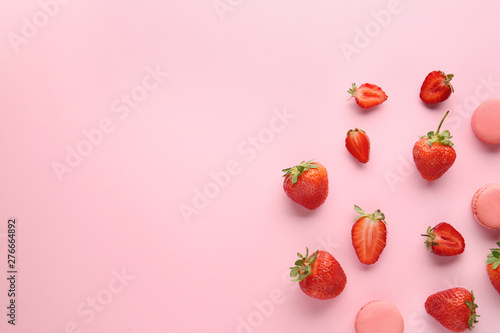 Sweet ripe strawberry and macarons on color background