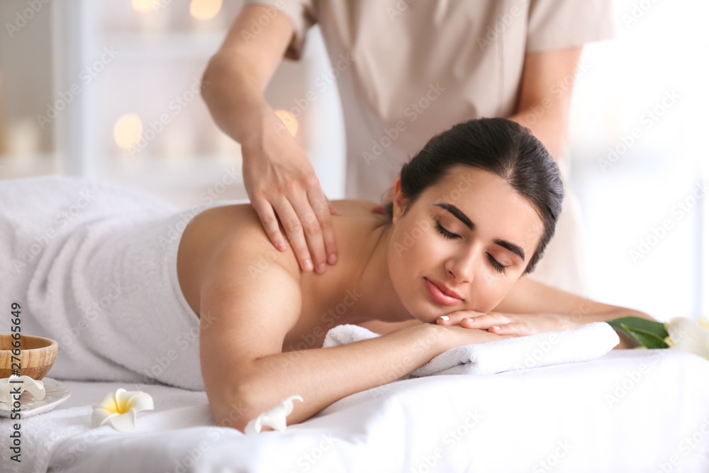 Beautiful young woman receiving massage in spa salon Beautiful young woman receiving massage in spa salon