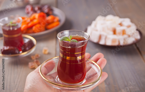 Turkish tea in traditional glass cups and turkish sweets