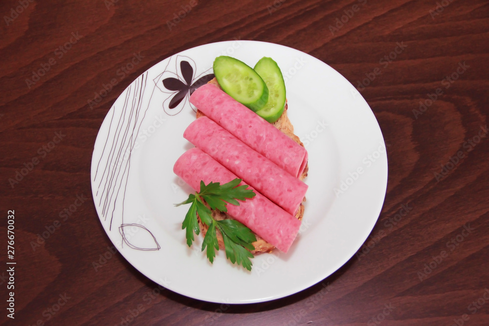 sandwich of rye bread with meat sausage, cucumbers and parsley sandwich of rye bread with meat sausage, cucumbers and parsley