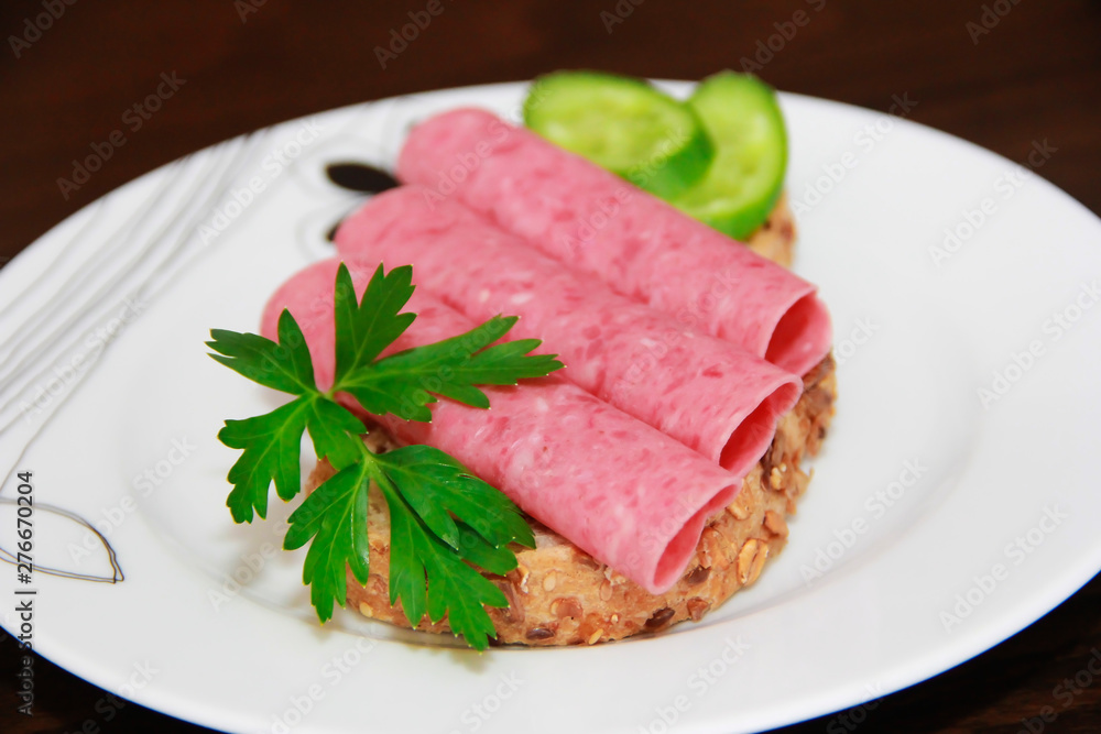 sandwich of rye bread with meat sausage, cucumbers and parsley sandwich of rye bread with meat sausage, cucumbers and parsley