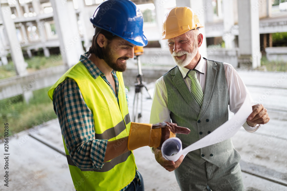 Team of architects and engineer in group on construciton site check documents and business workflow Team of architects and engineer in group on construciton site check documents and business workflow