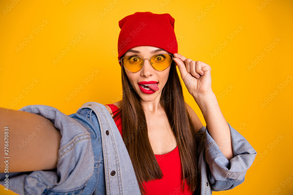 Close up photo of cute trendy teen make faces grimacing touch eyewear eyeglasses isolated over yellow background Close up photo of cute trendy teen make faces grimacing touch eyewear eyeglasses isolated over yellow background