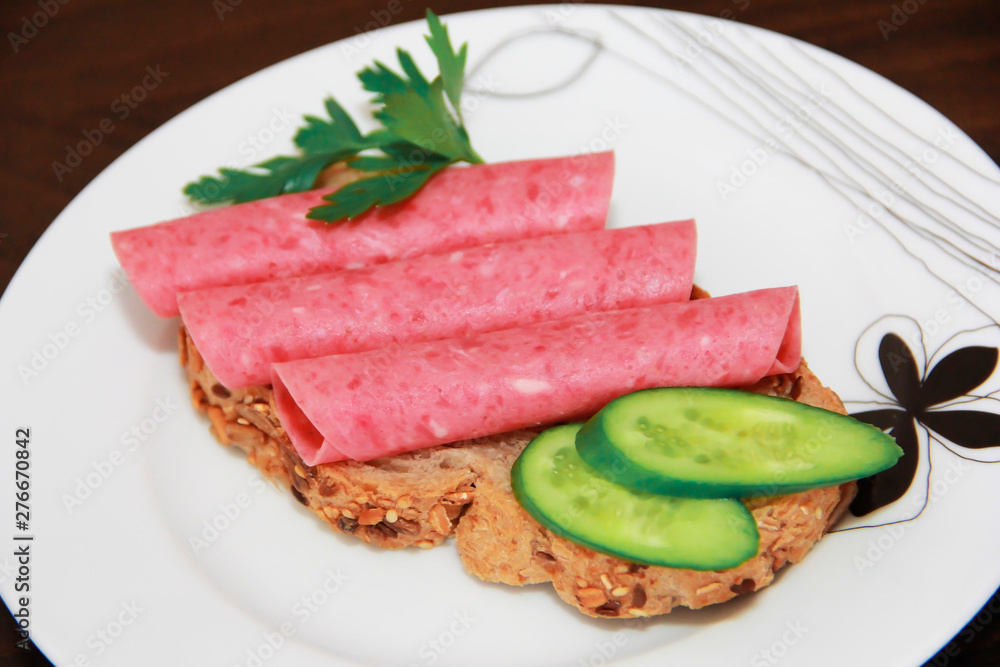 sandwich of rye bread with meat sausage, cucumbers and parsley sandwich of rye bread with meat sausage, cucumbers and parsley