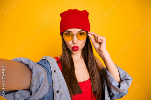 Close up photo of charming trendy lady send air kisses make photo isolated over yellow background
