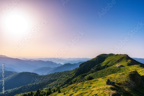 Beautiful clear sky summer sunset in the mountains. Landscape with sun light shining