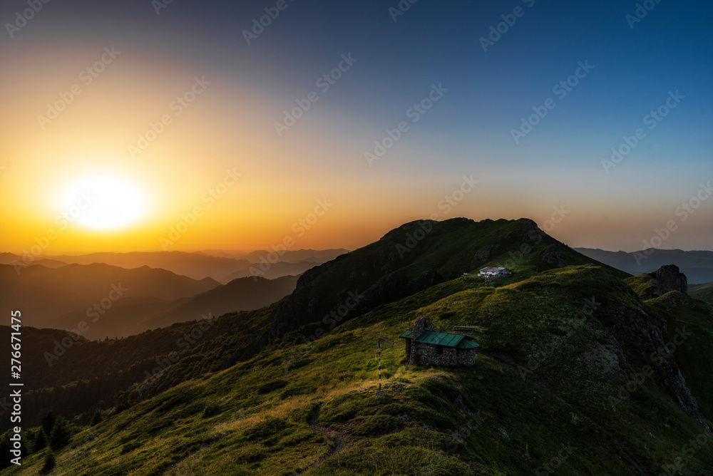 Beautiful clear sky summer sunset in the mountains. Landscape with sun light shining