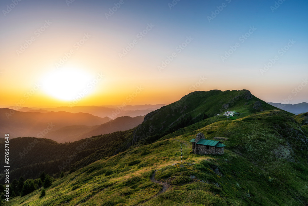 Beautiful clear sky summer sunset in the mountains. Landscape with sun light shining