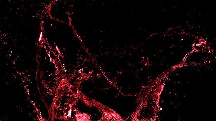Abstract red wine splash shape on black background