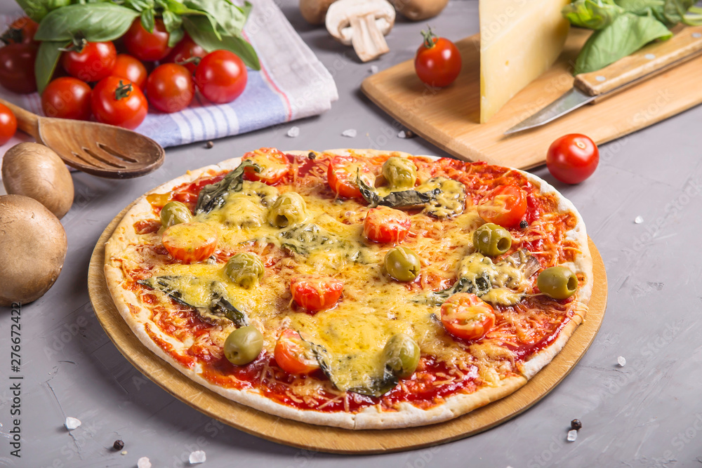 Fast homemade vegetarian pizza with mushrooms on a gray table Fast homemade vegetarian pizza with mushrooms on a gray table